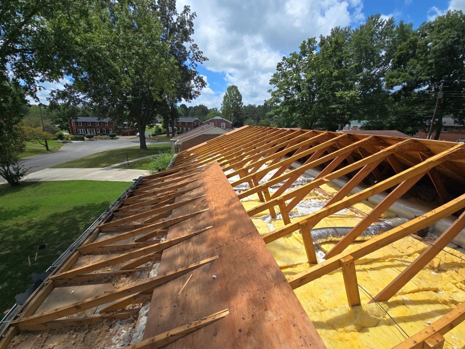 Roof decking going on over exposed rafters